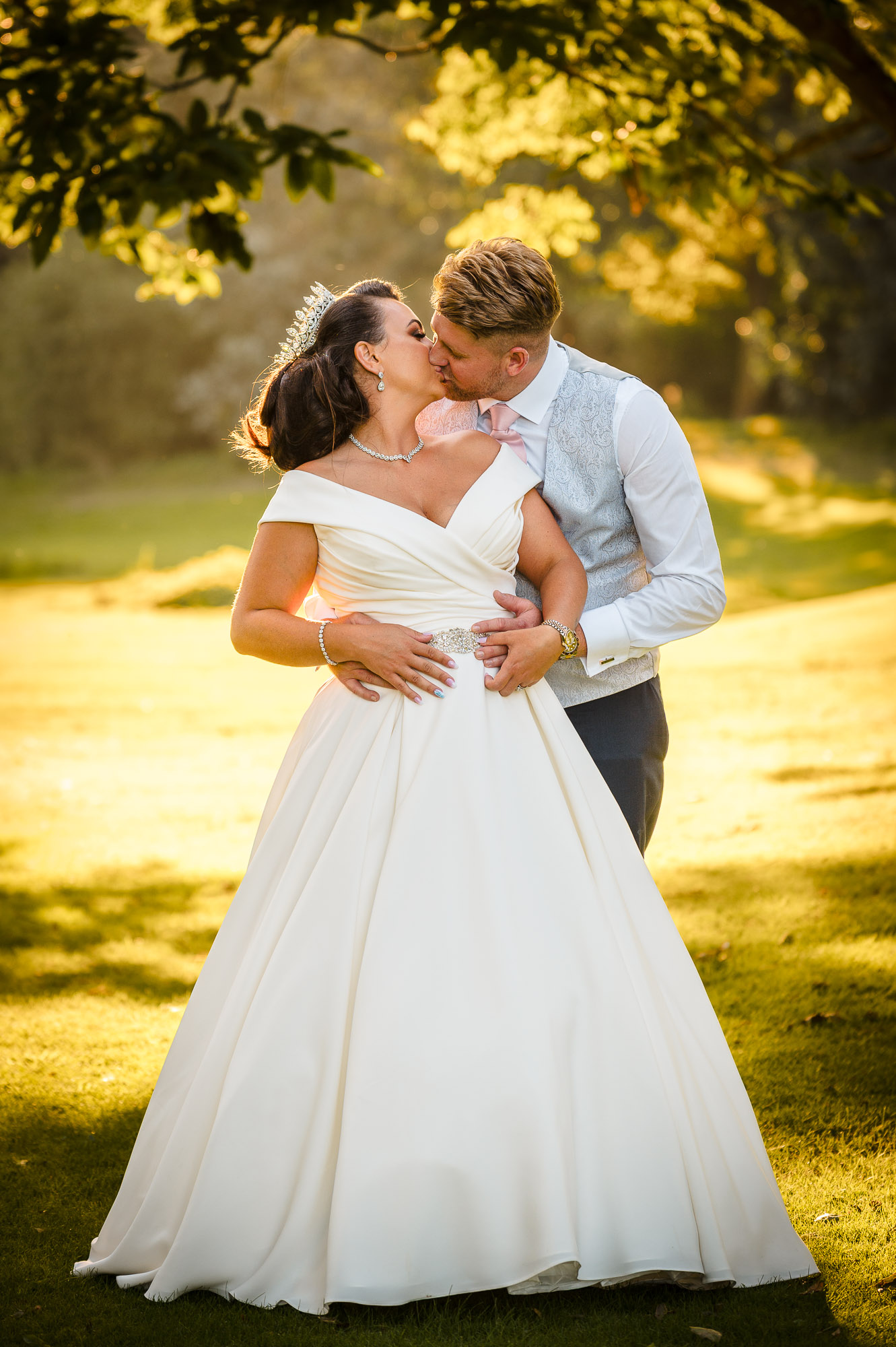 Sunset portrait of the bride and groom kissing at Mercure Maidstone Great Danes Hotel, Maidstone, Kent