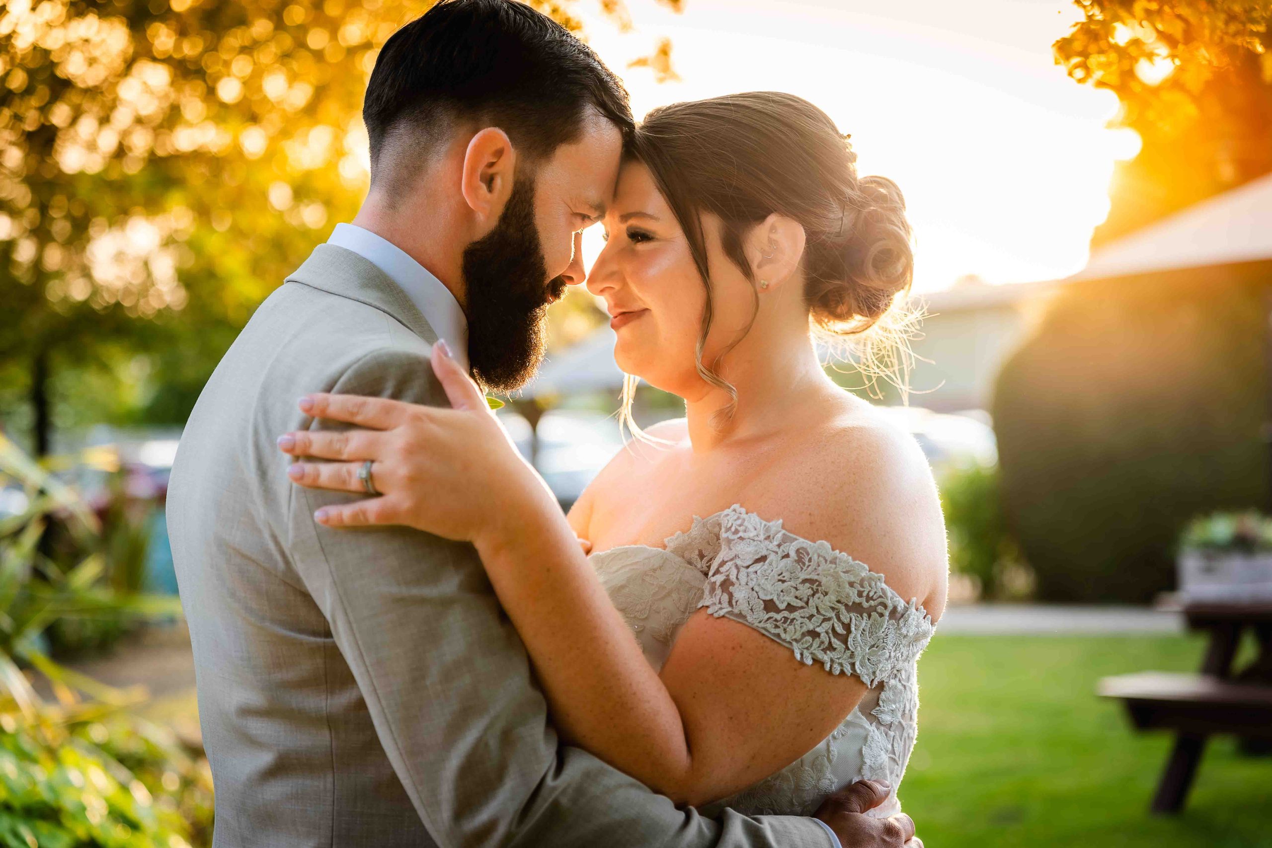 Bride and groom backlit by sunset at The Moat at Wrotham, London Road, Wrotham, Kent