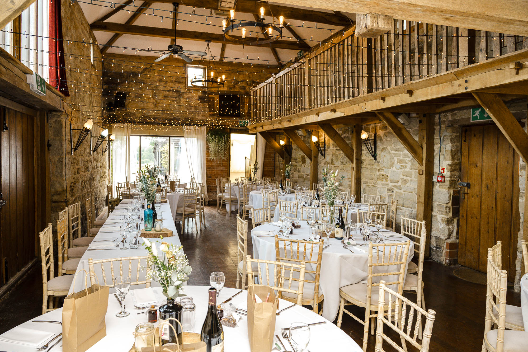 Interior wedding reception set-up in The Barn at Swallows Oast wedding venue, Ticehurst, East Sussex
