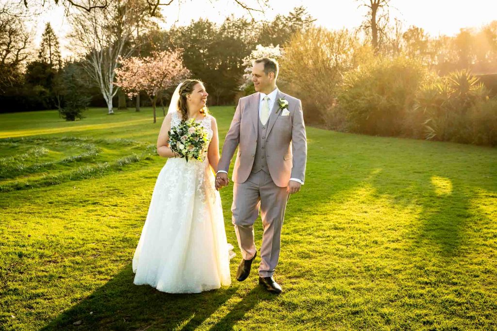 Bride and groom walking in the gardens at sunset at Hall Place & Gardens, Bexley, Kent
