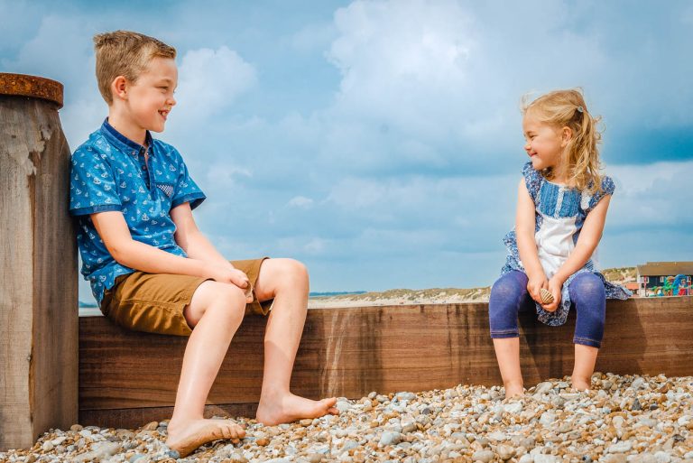 Camber Sands photo shoot, Sussex - son and daughter sitting on beach laughing