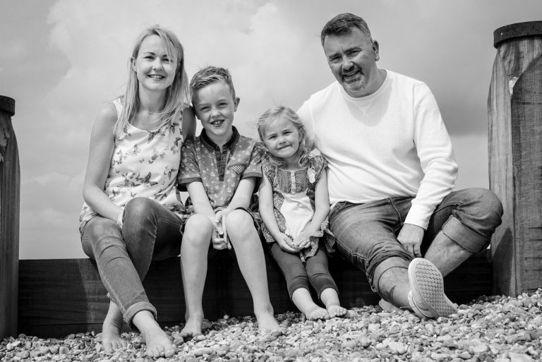 Camber Sands photo shoot, Sussex - family portrait in black and white sitting on the beach