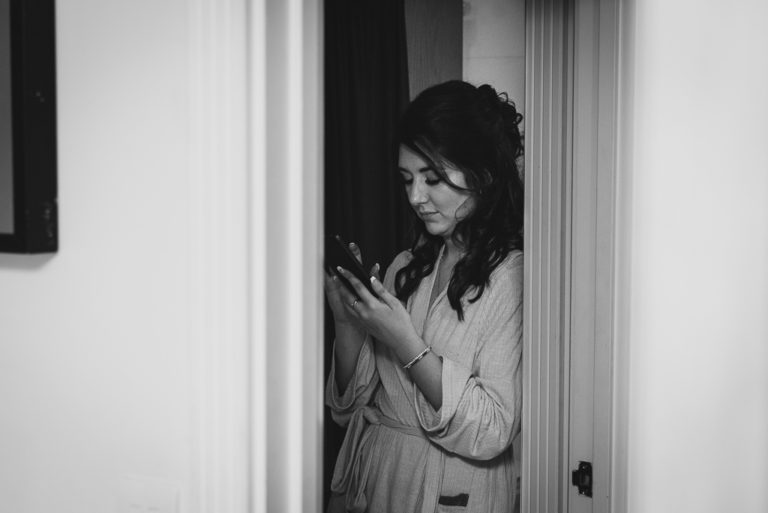 Quiet moment for a bridesmaid during bridal prep | Sidcup Wedding of Becky & Hugo | Oakhouse Photography