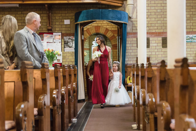 Bridesmaid and flowergirl walking down the aisle | Sidcup Wedding of Becky & Hugo | Oakhouse Photography