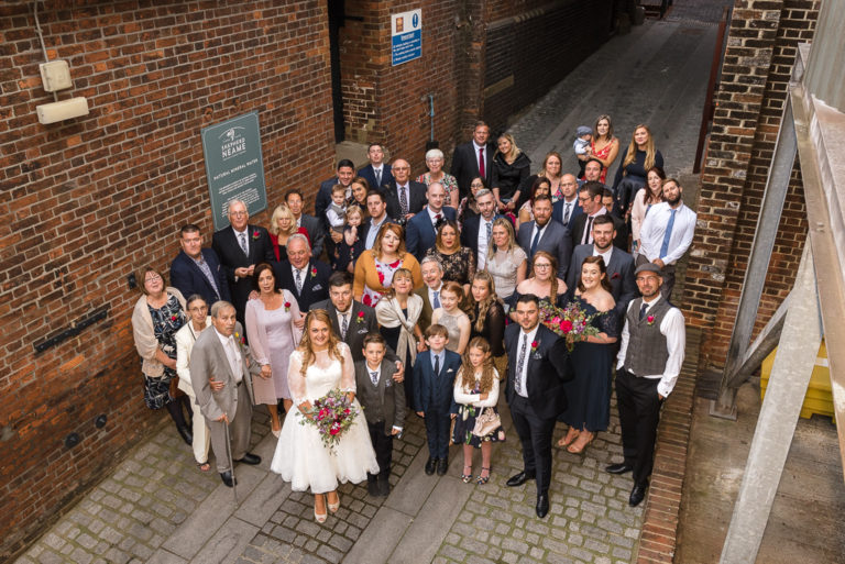 Wedding party group shot in The Street at the Shepherd Neame Brewery Faversham Kent | Oakhouse Photography