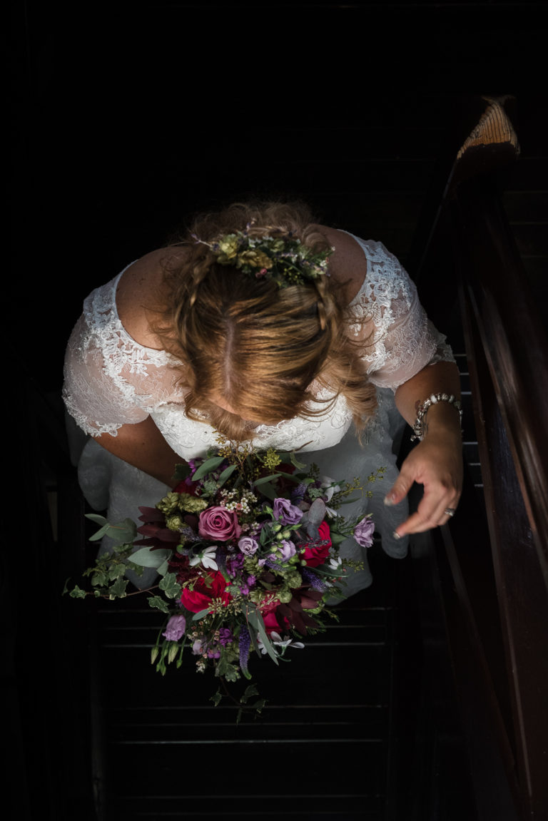 Creative wedding photograph of bride descending stairs at Shepherd Neame Brewery Faversham Kent | Oakhouse Photography