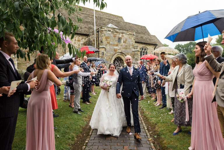 Confetti being thrown over the bride and groom at Wadhurst Church, Wadhurst, East Sussex | Oakhouse Photography