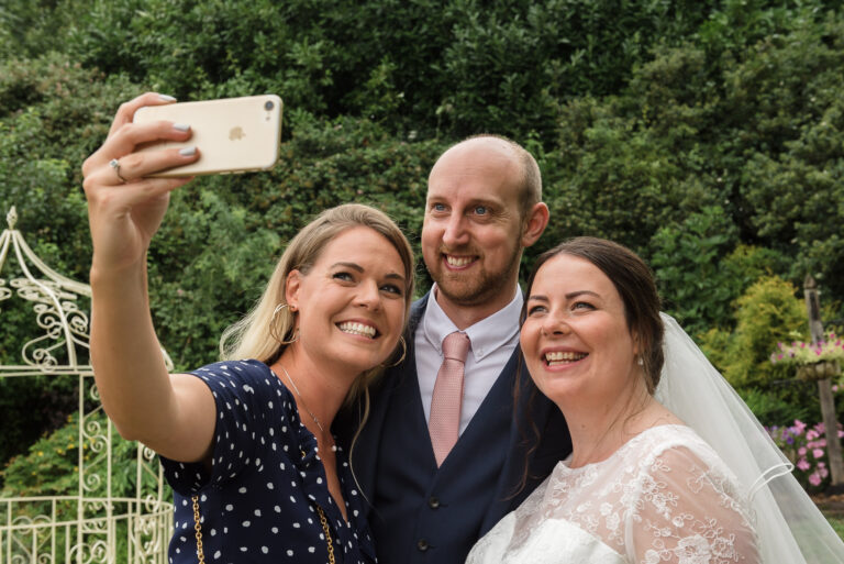 Groom having a selfie taken with wedding guests at Swallows Oast wedding venue, Ticehurst, East Sussex | Oakhouse Photography