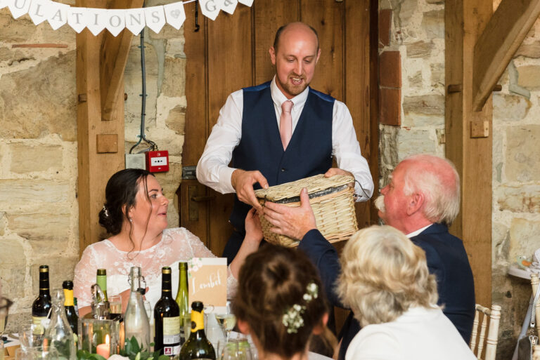 Groom presenting gifts to the father and mother of the bride at Swallows Oast wedding venue, Ticehurst, East Sussex | Oakhouse Photography
