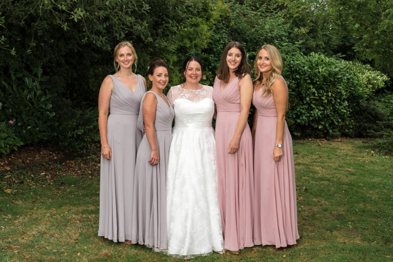 Bride and bridesmaids group photograph at Swallows Oast wedding venue, Ticehurst, East Sussex | Oakhouse Photography