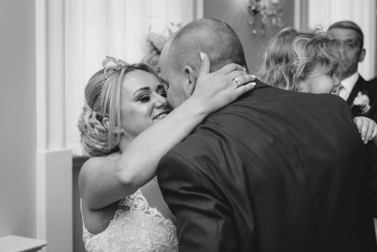 First kiss between the bride and groom after getting married at Chelsea Old Town Hall, King’s Road, London | Oakhouse Photography