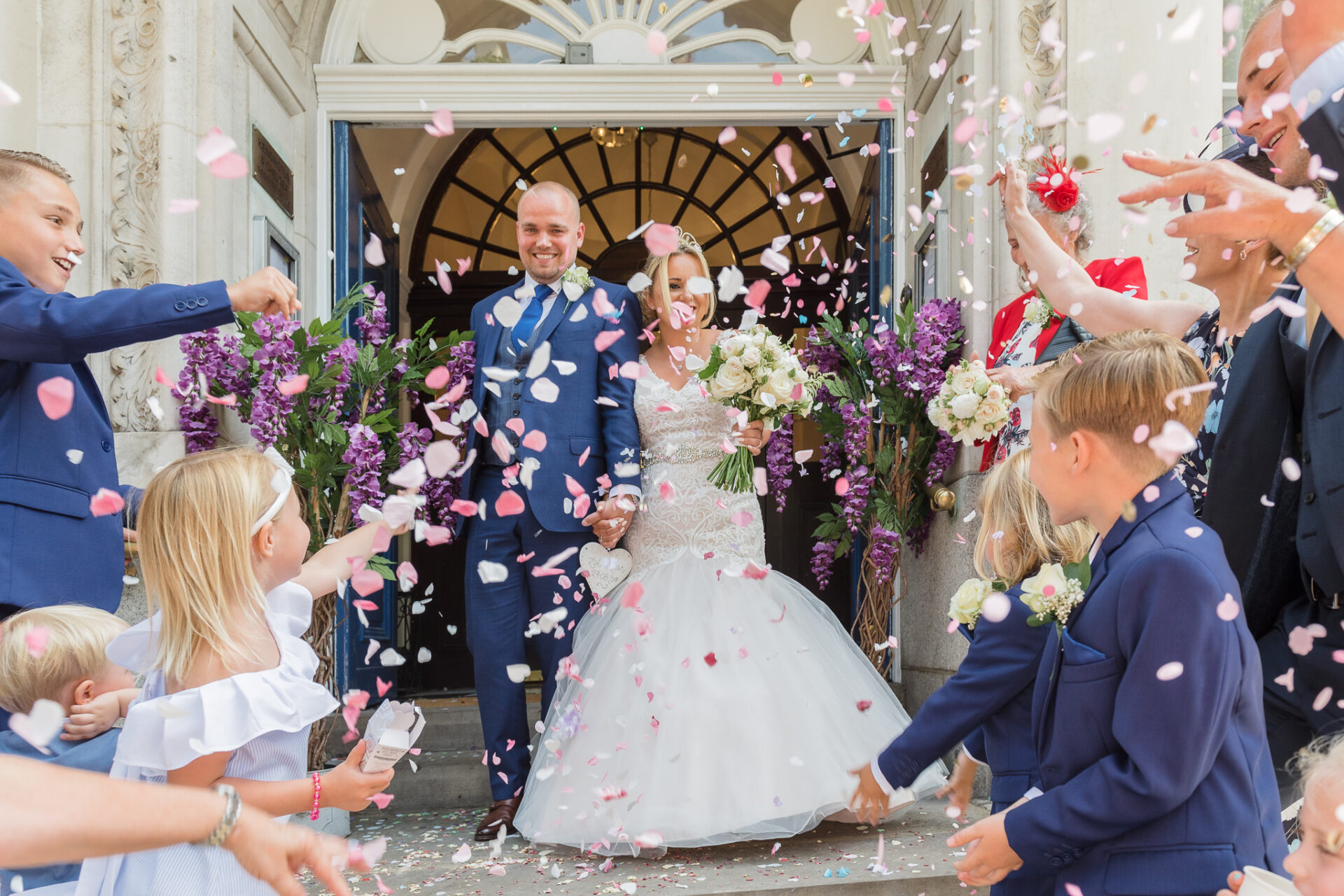 Bride and groom being showered with confetti on leaving Chelsea Old Town Hall, King’s Road, London | Oakhouse Photography