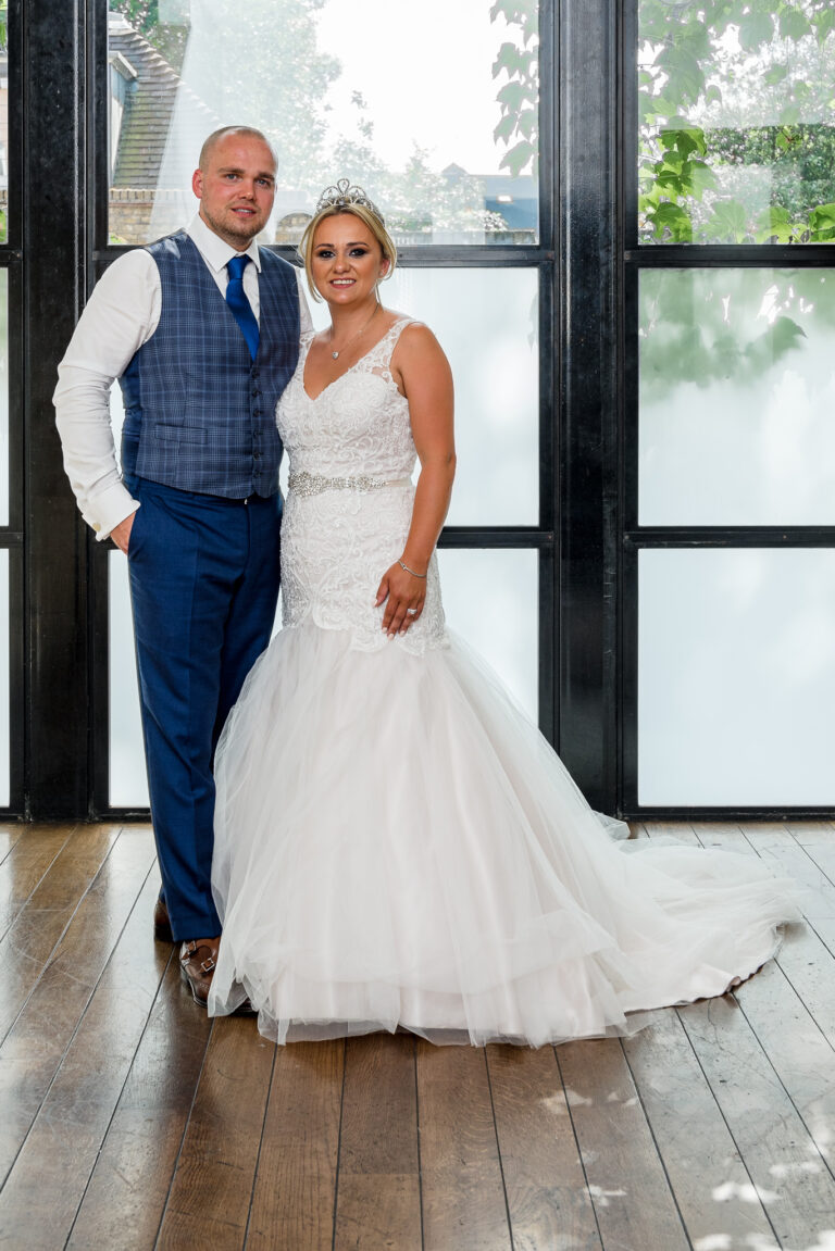 Full length portrait photograph of the bride and groom taken at the Bluebird Chelsea restaurant in London