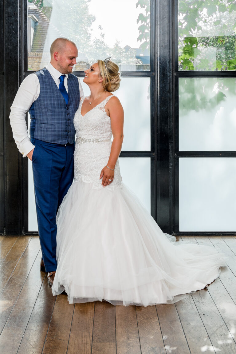 Full length portrait photograph of the bride and groom taken at the Bluebird Chelsea restaurant in London