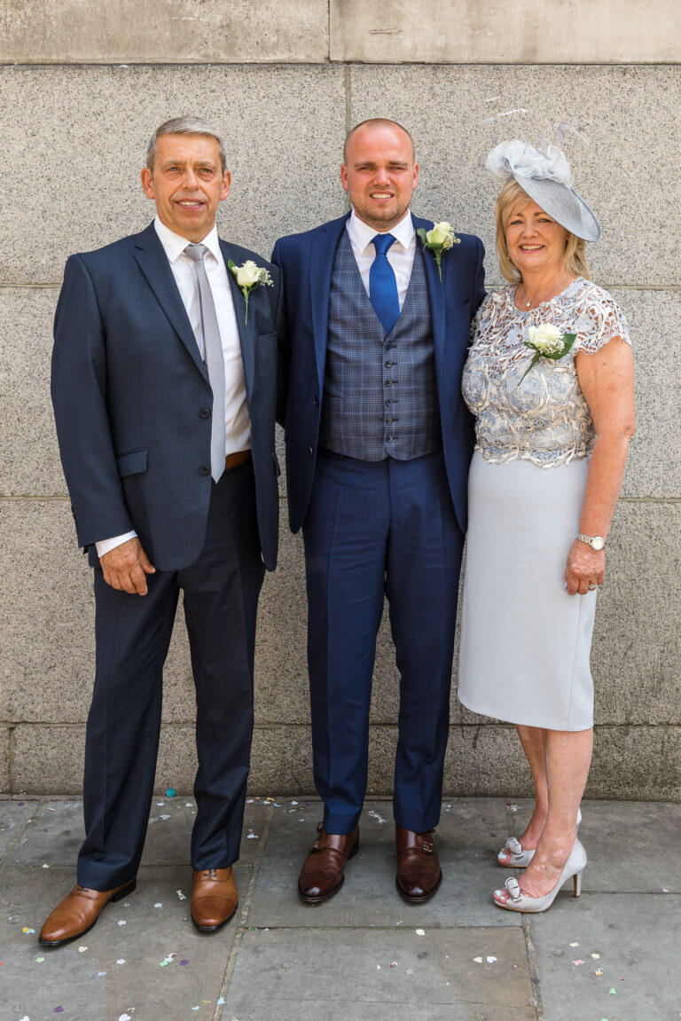 Groom and parents outside Chelsea Old Town Hall, King’s Road, London for a group shot before his wedding | Oakhouse Photography