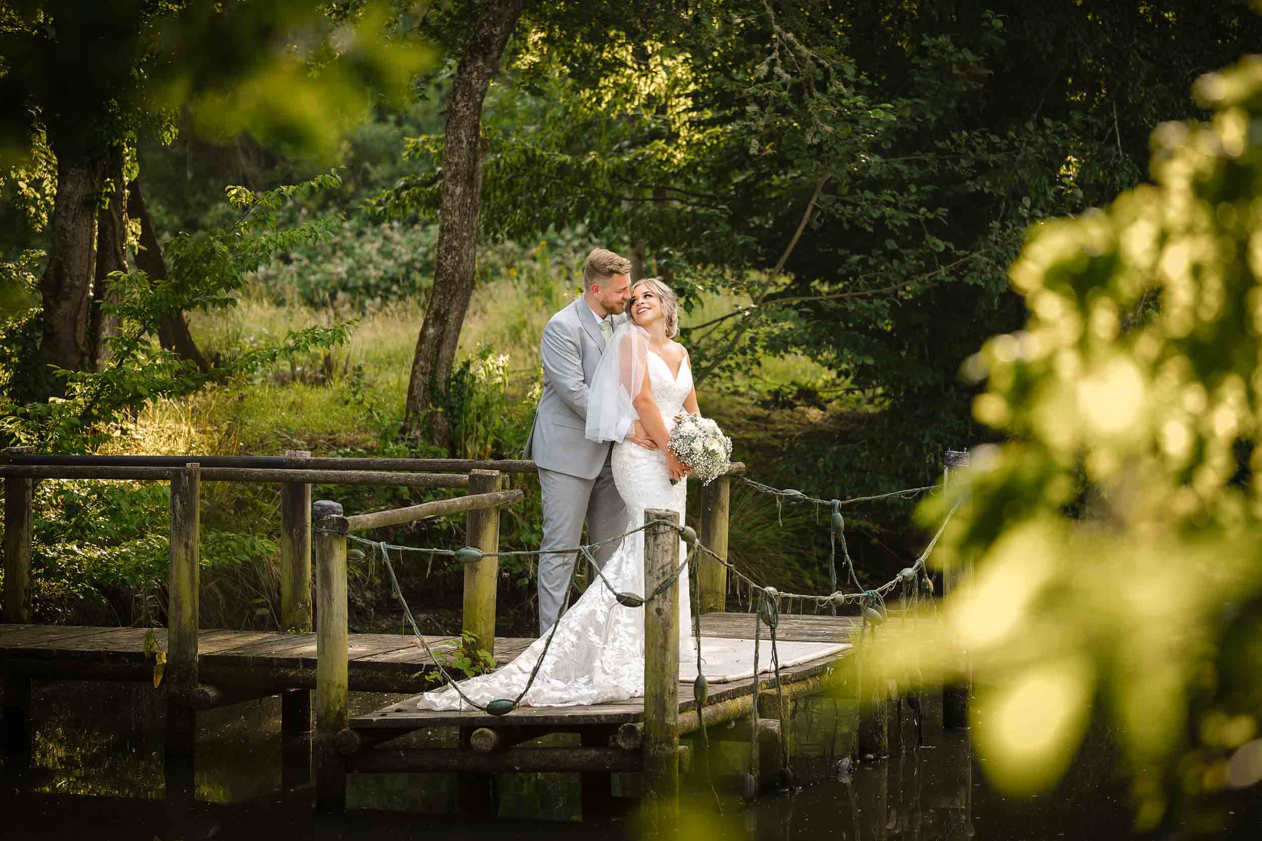 Swallows Oast Wedding Photographer. Bride and Groom on jetty at Swallows Oast wedding venue, Ticehurst, Sussex.
