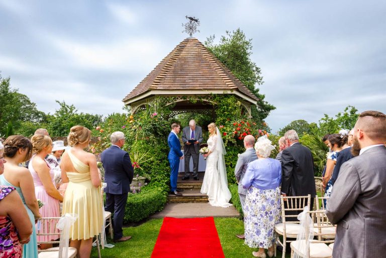 Bride and groom getting married outdoors at The Knowle Country House, Higham, Medway, Kent
