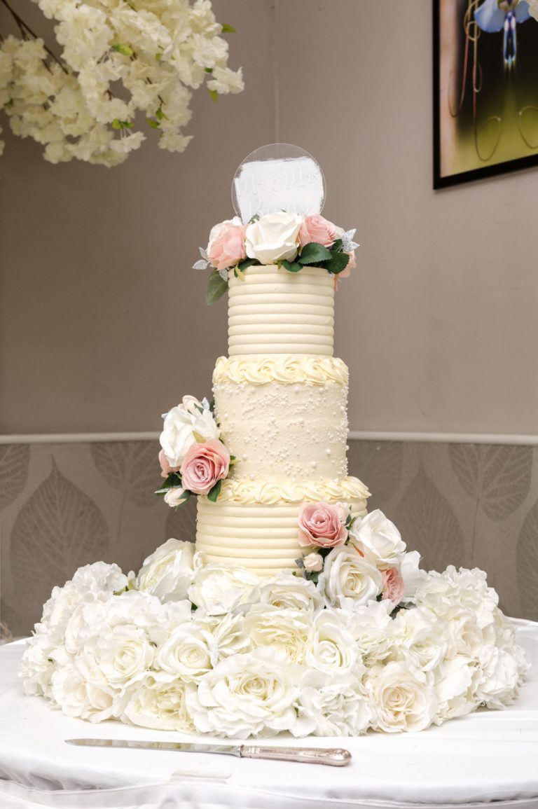Wedding cake in the ballroom at the Mercure Maidstone Great Danes Hotel wedding