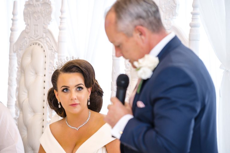 Bride listening to her father's speech at the Mercure Maidstone Great Danes Hotel wedding
