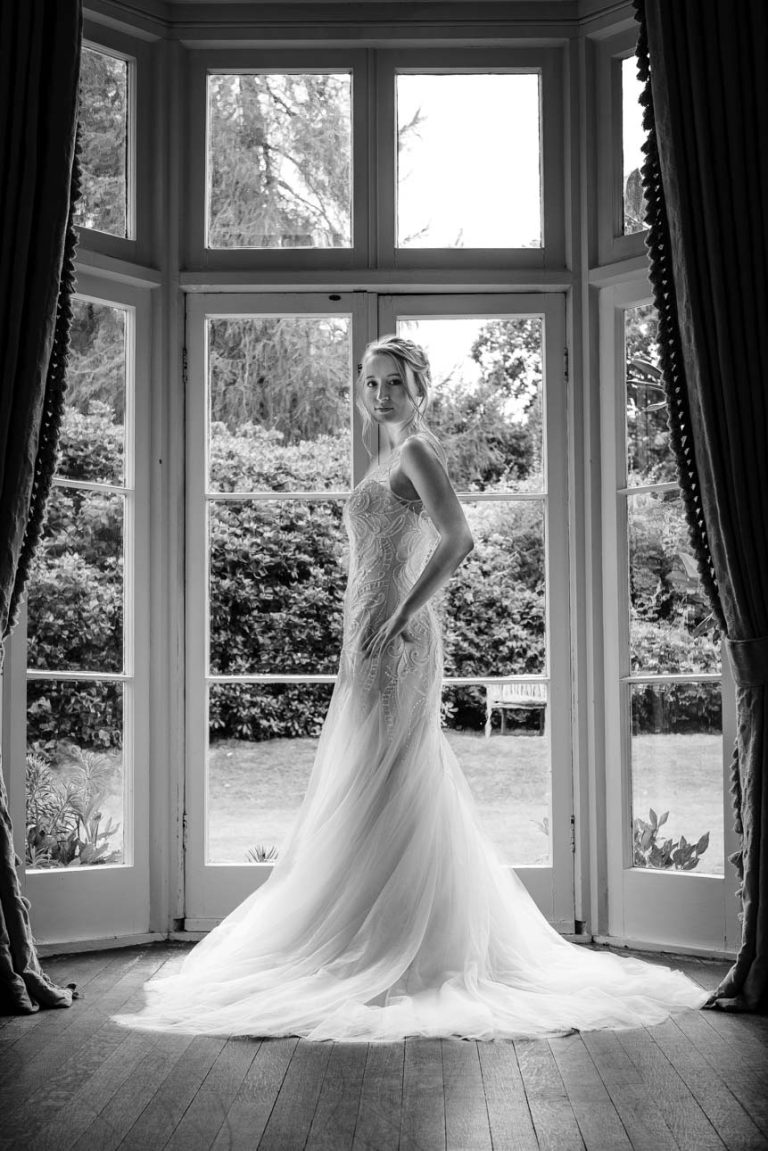 Portrait of bride in front of double doors to garden at Sprivers Mansion wedding venue, Kent