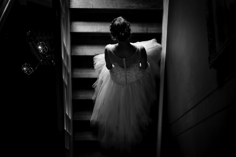 Image of bride ascending the staircase at Sprivers Mansion wedding venue, Kent