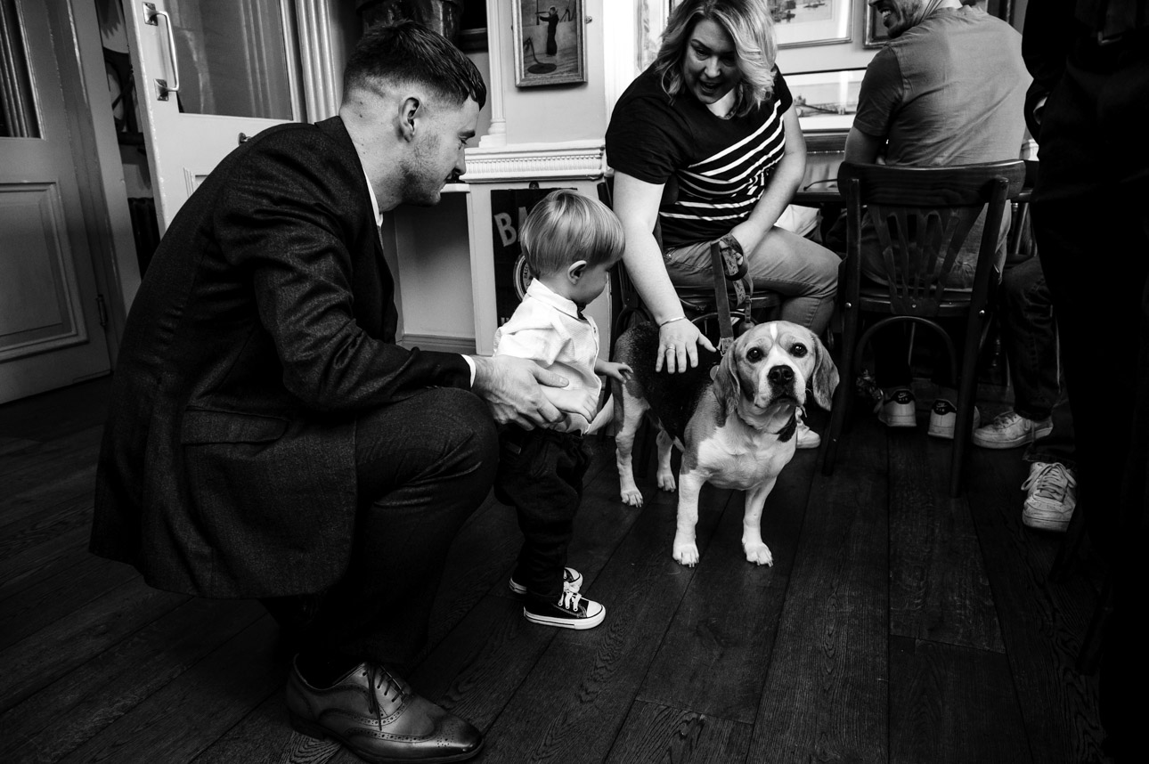 Guests and pet dog in the bar prior to the wedding ceremony at the Trafalgar Tavern, Greenwich | Oakhouse Photography