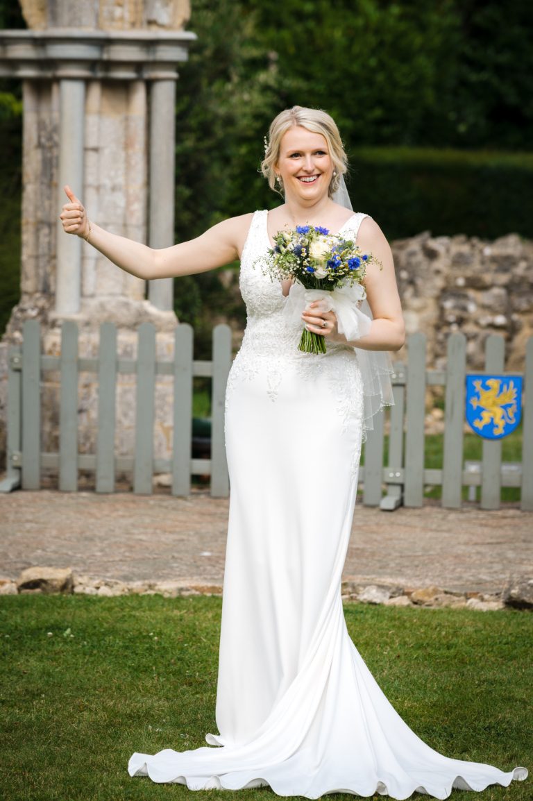 Bride with thumbs up at her wedding ceremony at The Domus, Beaulieu, Hampshire