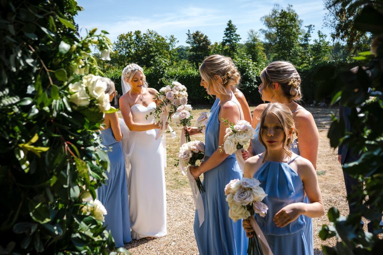 Bride with her bridesmaids entering the church for her Hampshire wedding