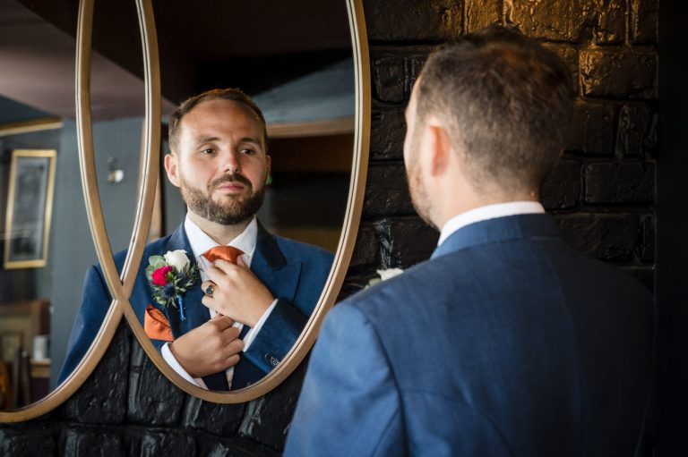 Groom getting ready for his wedding at Hampton Court Palace Golf Club