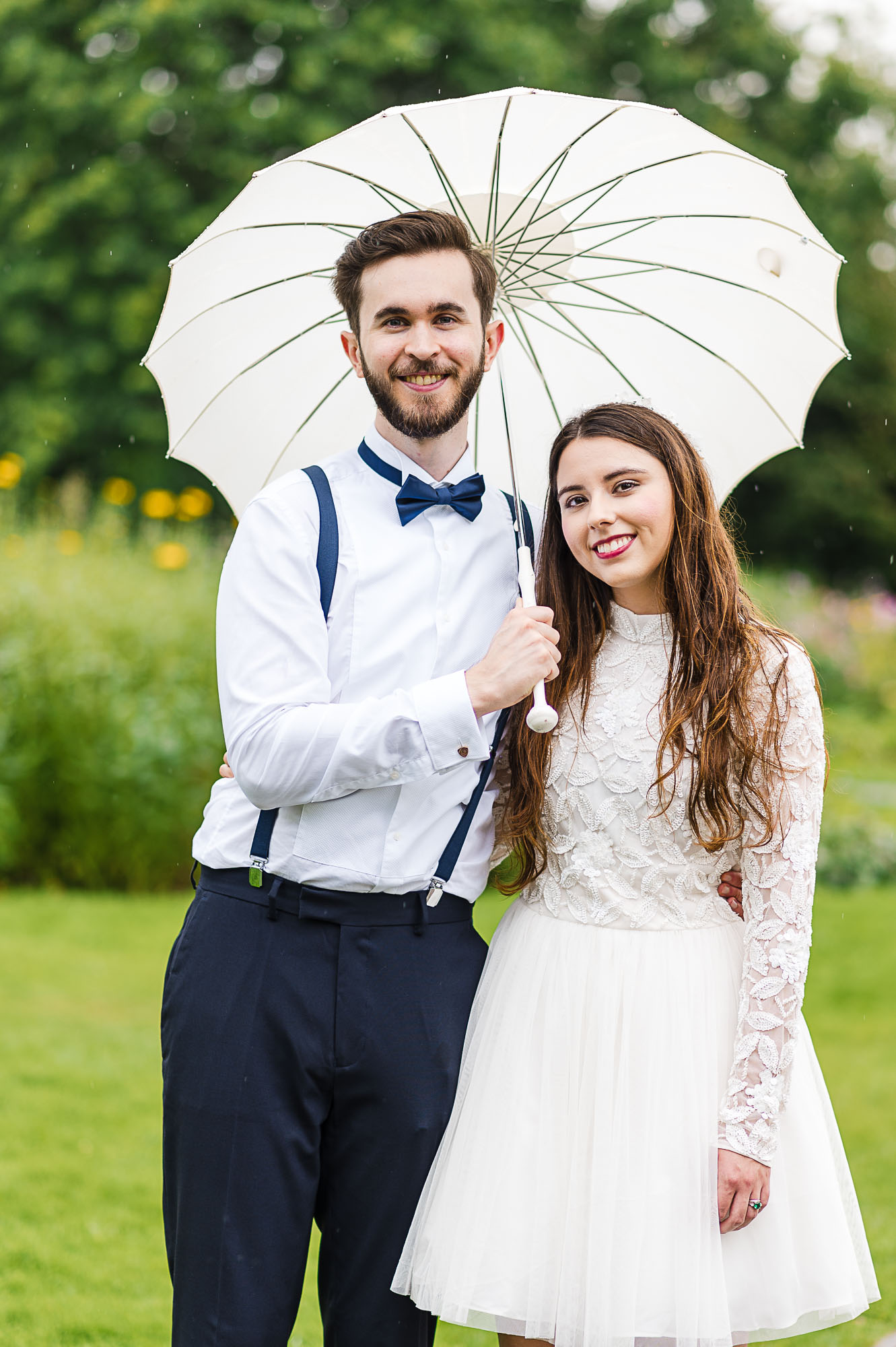 Bride and groom portrait holding a parasol umbrella in The English Garden, Danson Park, Bexleyheath