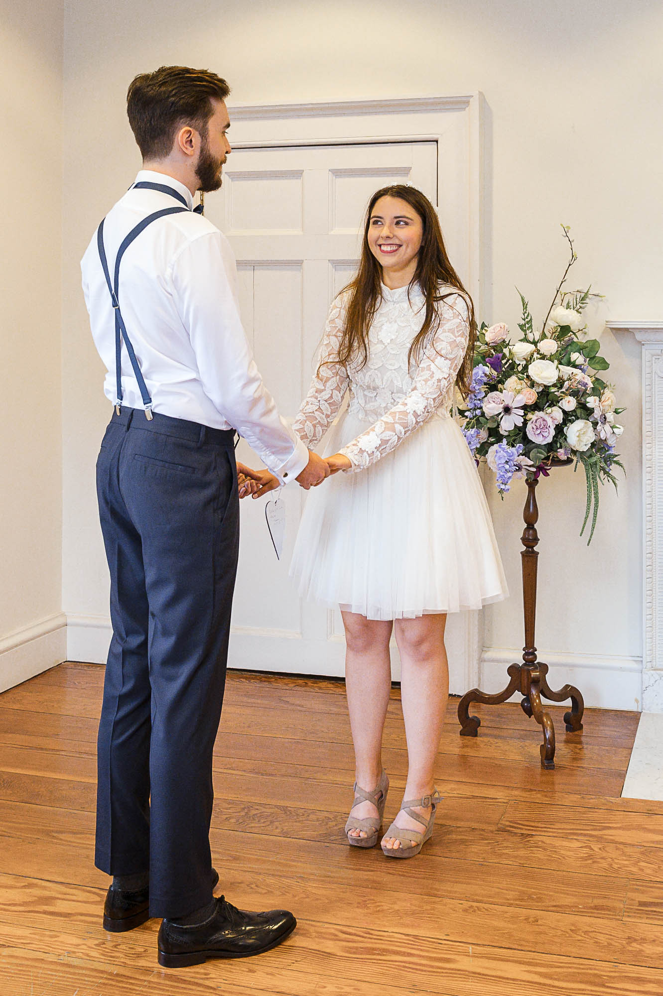 Bride and groom looking at each other during their wedding ceremony in The Johnson Room at Danson House, Danson Park, Bexleyheath, Kent