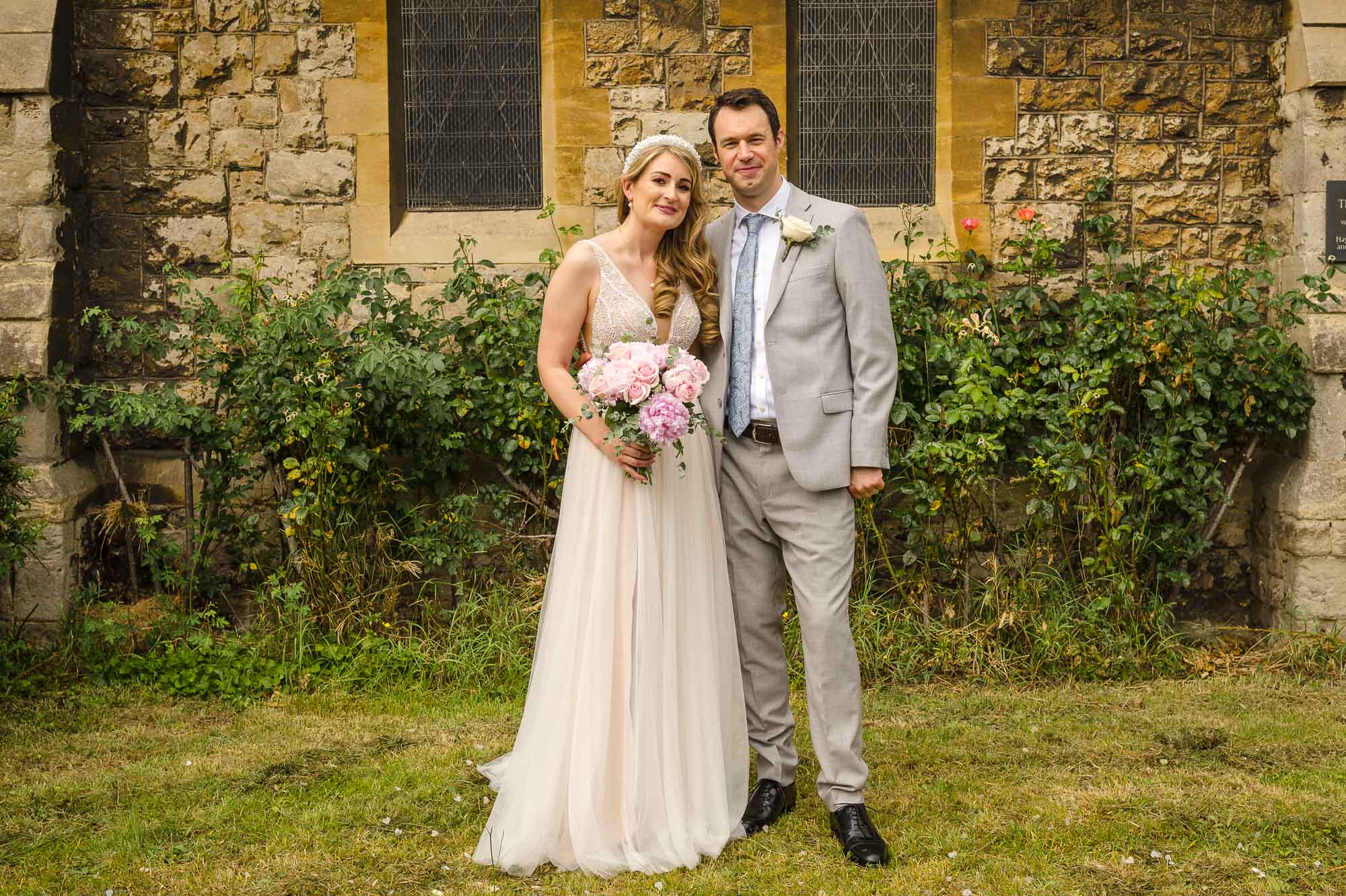 Portrait of the bride and groom in front of St John the Baptist Church in Eltham, London