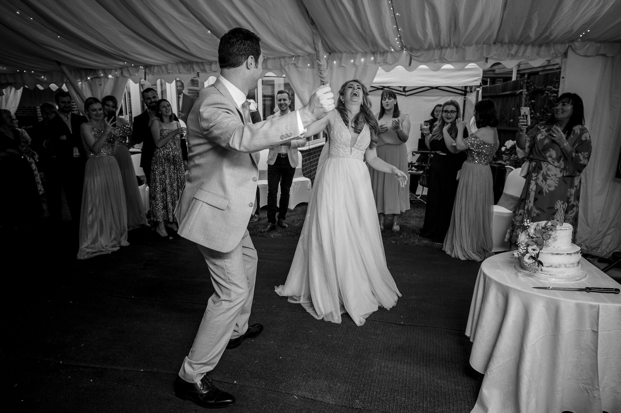 Groom dancing with his bride at a South East London wedding in a marquee