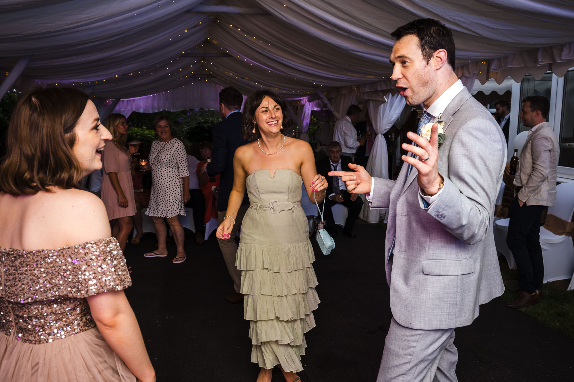 Groom dancing with wedding guests at a South East London wedding in a marquee