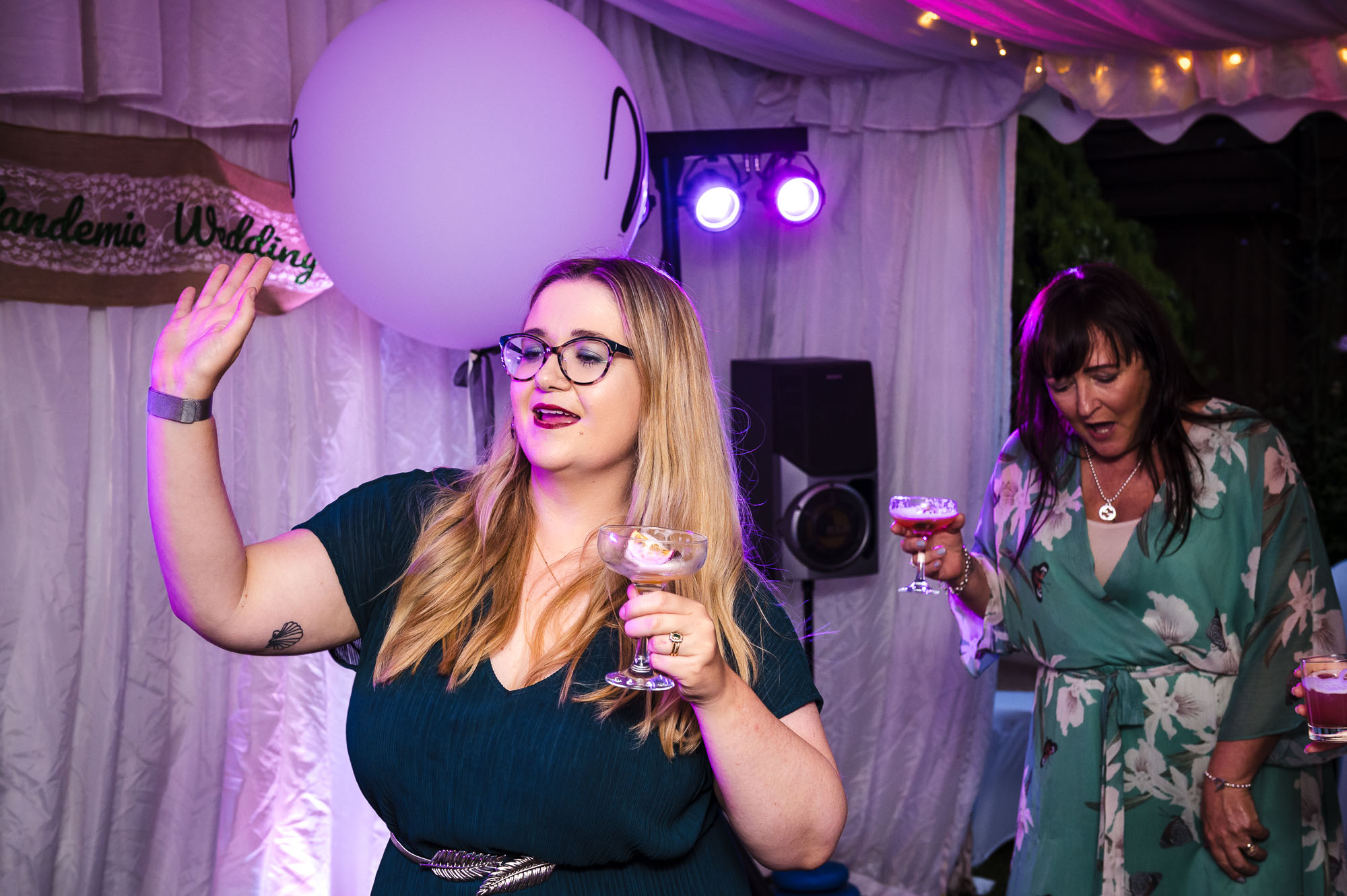 Wedding guests dancing while drinking cocktails at a London wedding