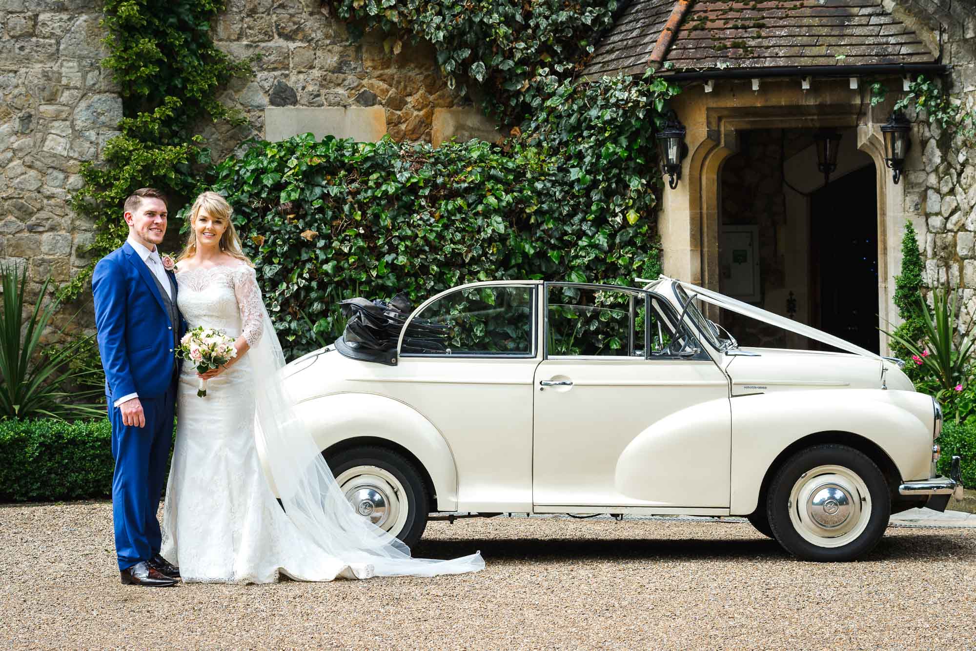 Bride and groom portrait next to a vintage VW Beetle car at The Knowle Country House, Higham Kent
