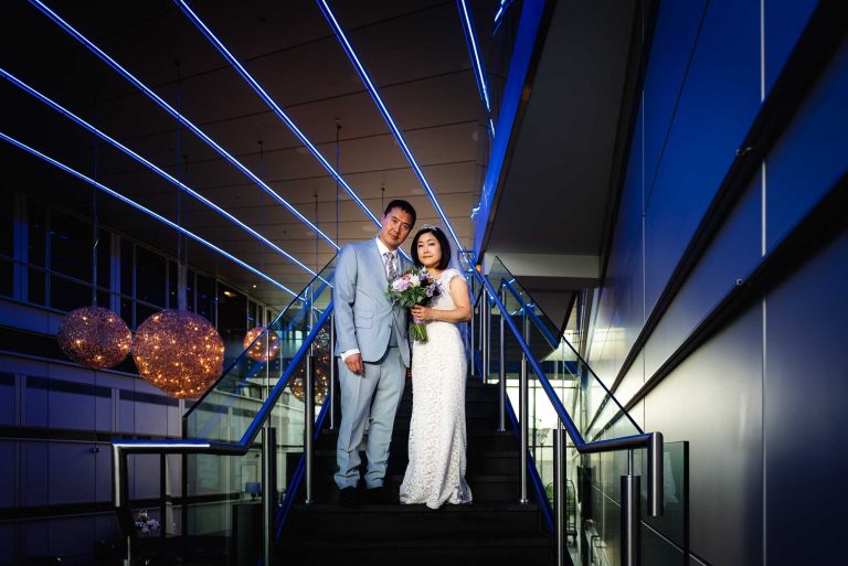 Wedding inspiration shot using off-camera flash of a bride and groom in low light at the Radisson Bu Edwardian New Providence Wharf in London