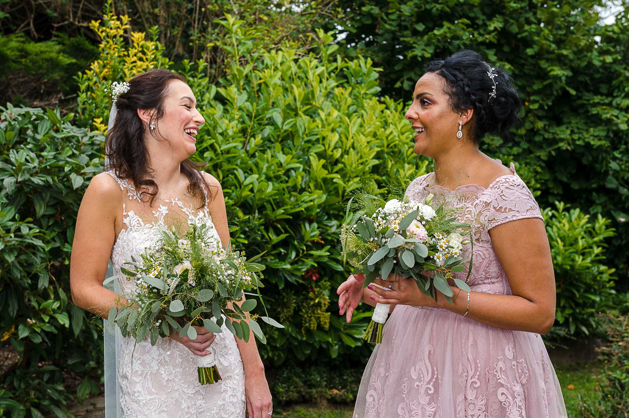 Bride and maid of honour laughing at Swallows Oast