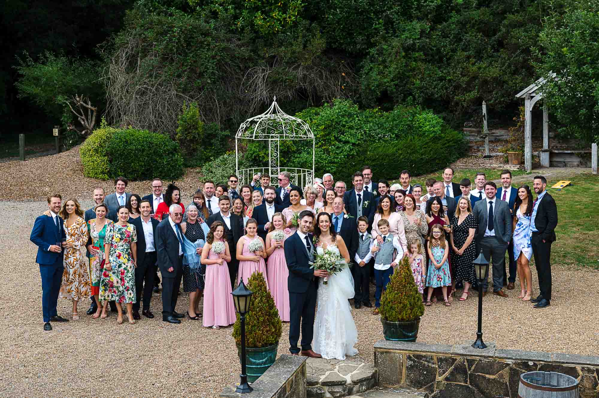 Whole wedding party group photograph at Swallows Oast wedding venue in Ticehurst, East Sussex