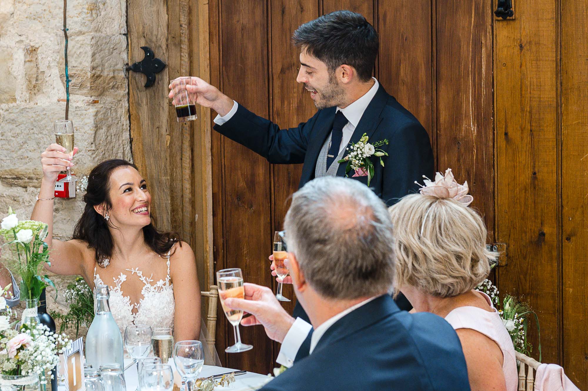 Groom toasting the bride during his speech during the reception at Swallows Oast wedding venue, Ticehurst, East Sussex
