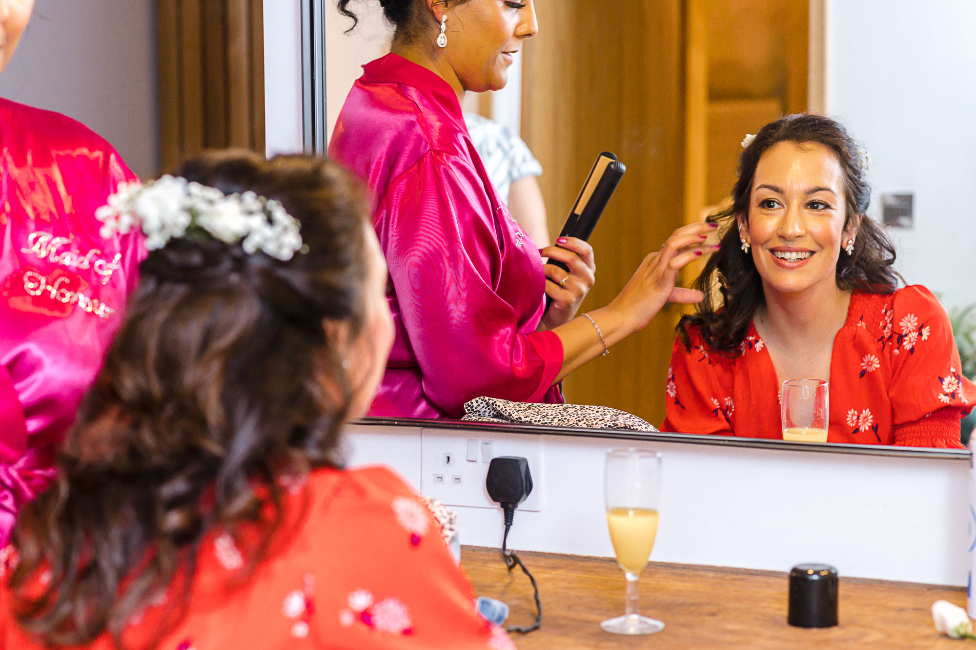 Bride having her hair styled during bridal prep in The Bridal Suite at Swallows Oast wedding venue in Ticehurst, East Sussex