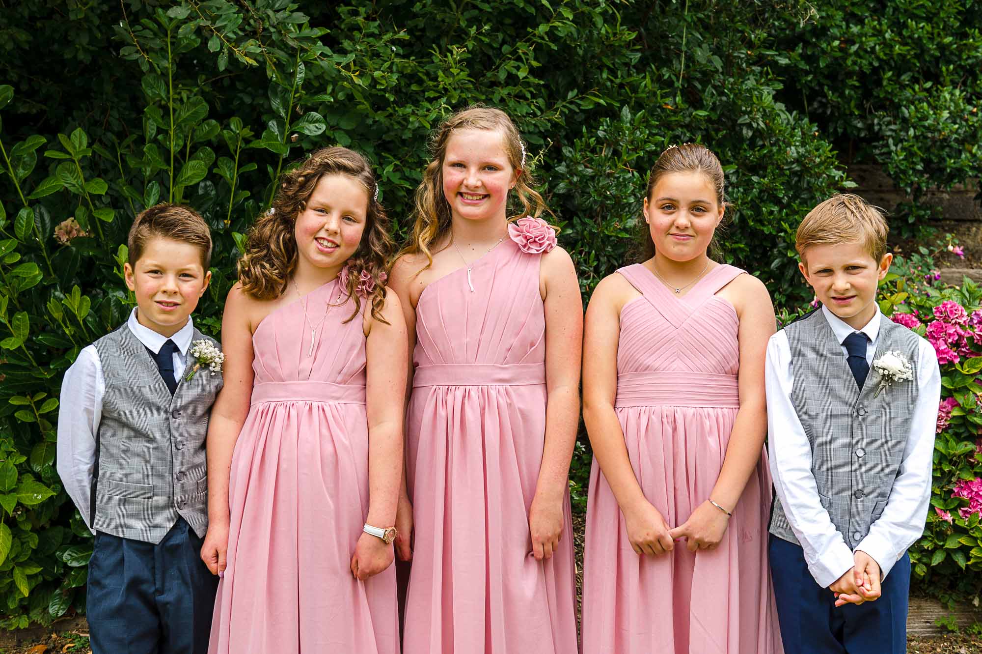 Portrait of bridesmaids and pageboys before the wedding ceremony at Swallows Oast wedding venue in Ticehurst, East Sussex
