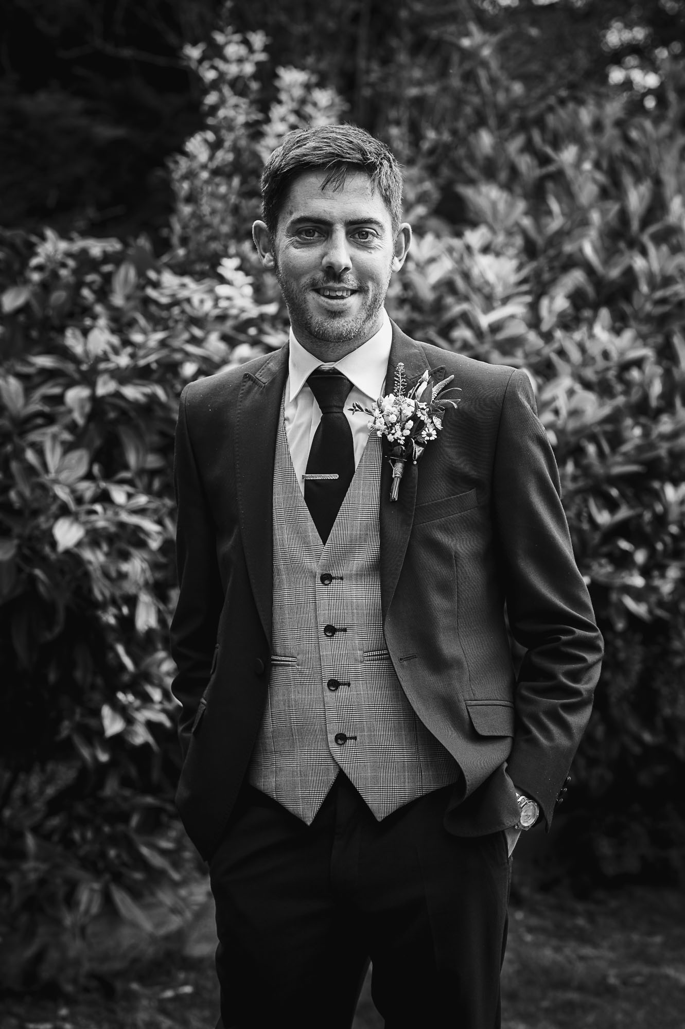 Portrait of groom in black and white before the wedding ceremony at Swallows Oast wedding venue in Ticehurst, East Sussex
