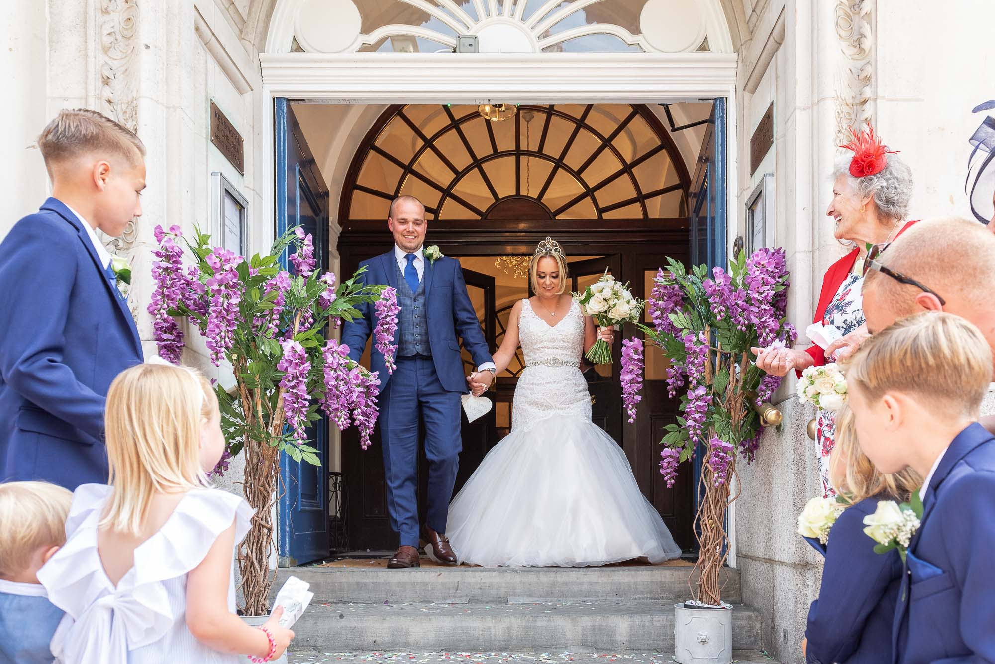 Bride and groom coming out onto the steps of Chelsea Old Town Hall registry office