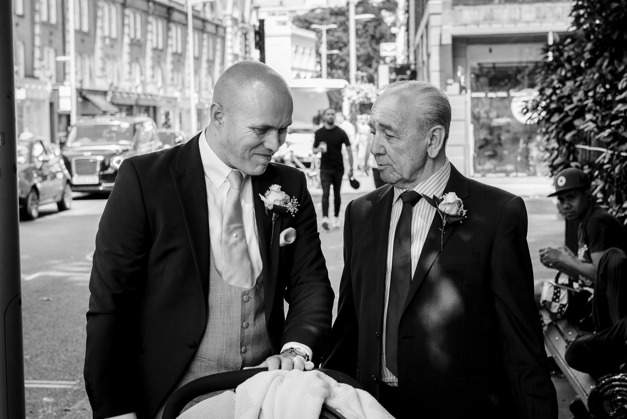 Bride's brother and guest on walk down the King's Road to Bluebird Chelsea wedding reception