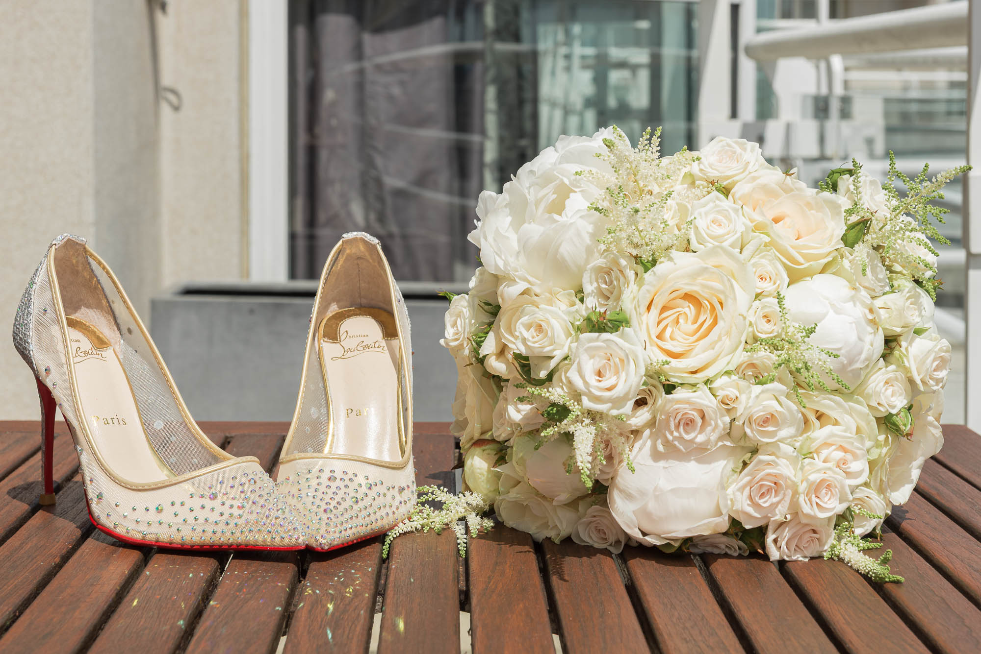 Wedding inspiration shot of flowers and brides shoes during bridal prep at Chelsea Harbour Hotel, London