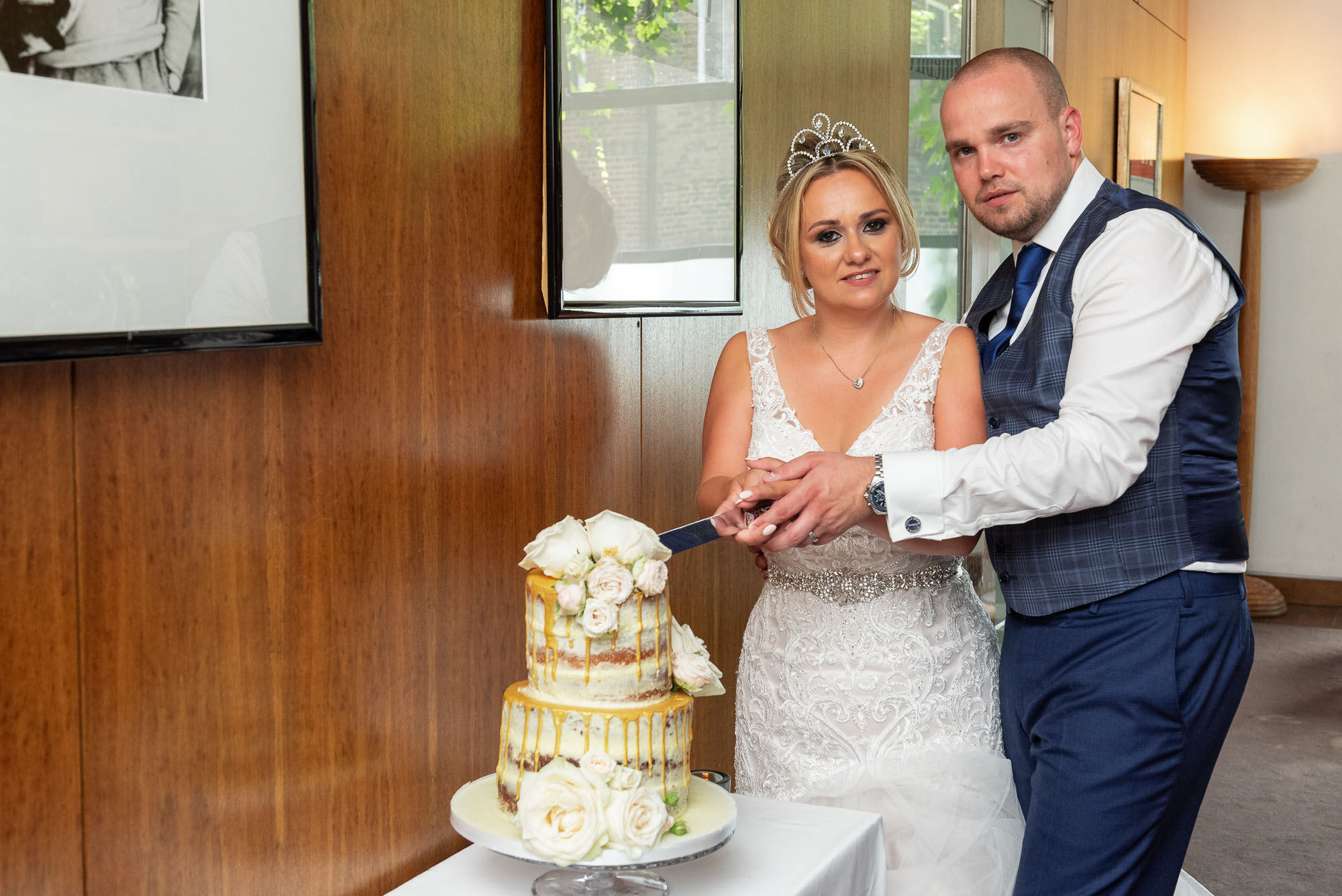 Bride & groom cutting the wedding cake at Bluebird Chelsea