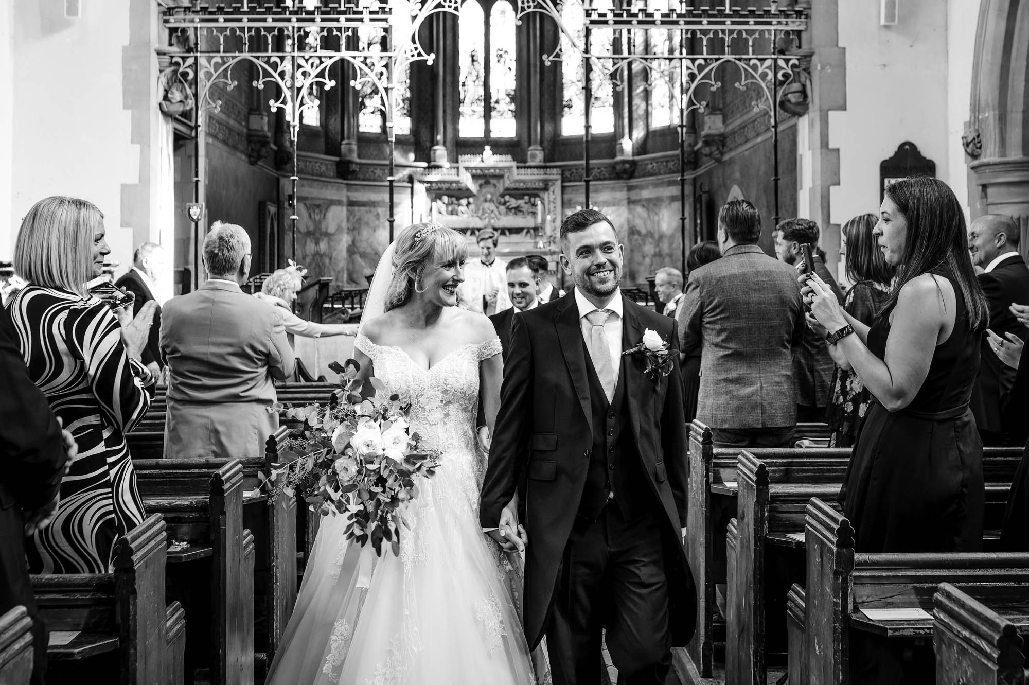 Bride and groom walking down the aisle after their wedding ceremony at St John the Evangelist Church, Bexley