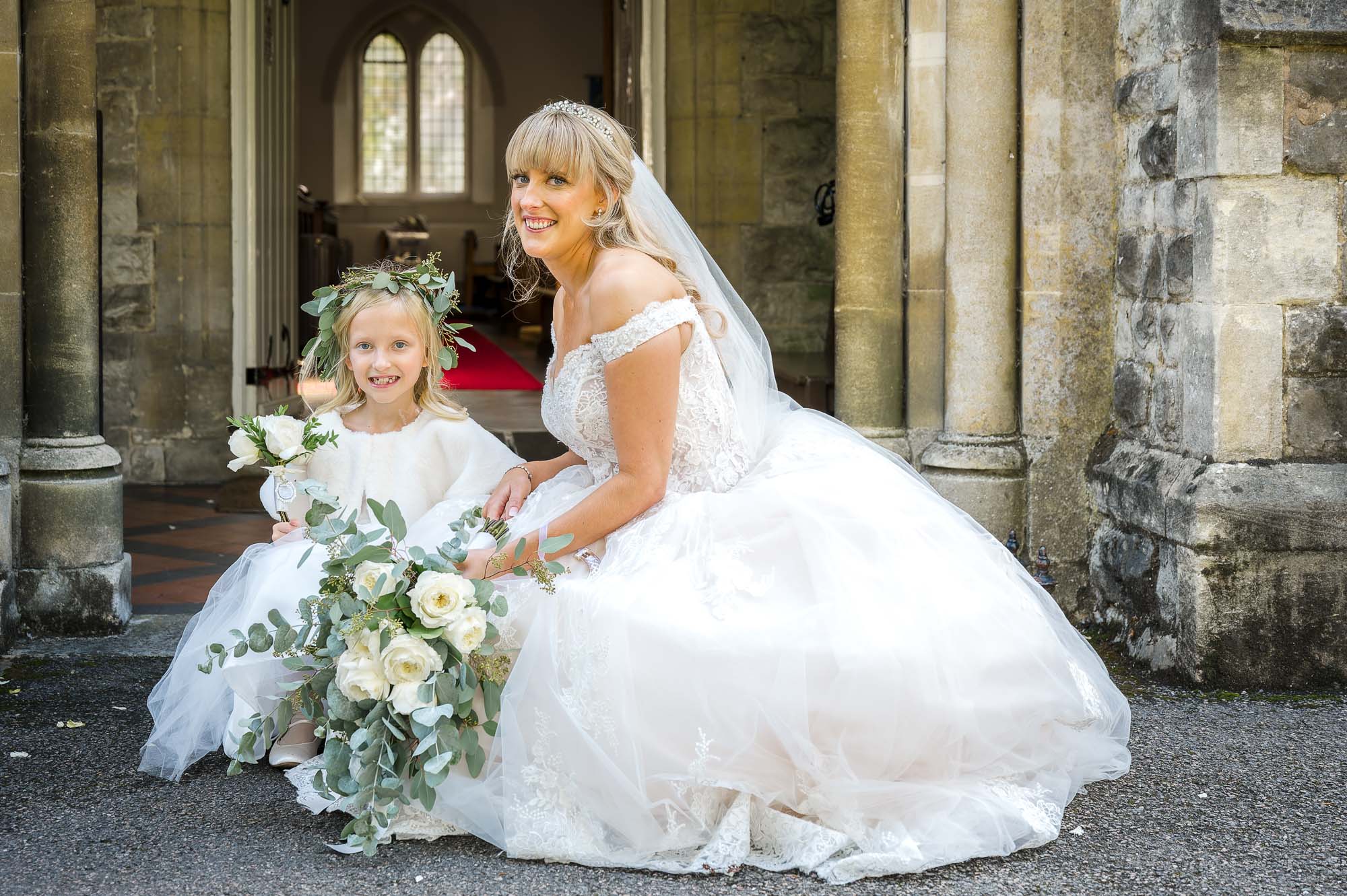 Bride and flowergirl portrait in front of St John the Evangelist Church, Bexley, Kent